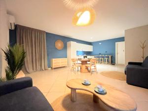 a living room with a table and a dining room at Aura Suites Napoli in Naples