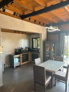 a kitchen with a table and chairs and a stove at Morada Sunset in Imaruí