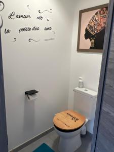 a bathroom with a toilet with a wooden seat at Guedon sandrine in Grosley-sur-Risle +8 photos