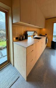 a kitchen with a sink and a counter top at Architect-Designed Cabin By Lake With Sauna in Homle