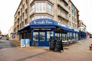 a store on a street in front of a building at Hotel Le Richelieu in Le Tréport
