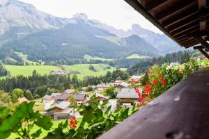 a view from a balcony of a village in the mountains at Salzburger Dolomitenhof in Annaberg im Lammertal