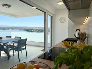 a kitchen with a table and a view of the water at Casa Bella in Malinska
