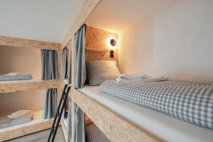 a room with two bunk beds in a room at Weitnau Stays - Hotel & Hostel in Weitnau +11 photos