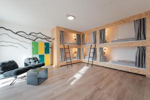 a room with two bunk beds and a couch at Weitnau Stays - Hotel & Hostel in Weitnau