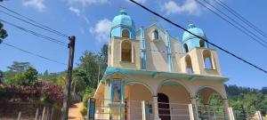 a church with blue domes on top of it at Pekoe House in Galaha Town +4 photos