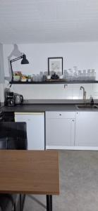 a kitchen with a sink and a counter top at Hochwald appartement in Bad Sachsa +28 photos