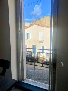 an open window with a view of a building at Le Calypso pour 4 pers CLIM CONFORT INTERNET PROCHE DE LA GARE in Marmande