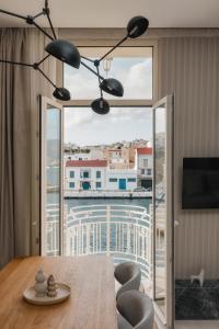 a dining room with a table and a large window at Luxury Suites by Lato in Agios Nikolaos +45 photos