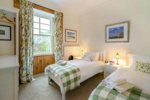 a bedroom with two beds and a window at 4 Bed in Pittenweem oc-t35090 in Pittenweem