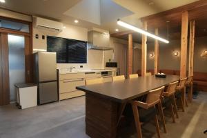 a kitchen with a large dining table and chairs at 侘然 - Wabizen - in Ikeda