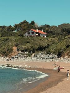 a group of people walking on a beach with a surfboard at Studio Biarritz Côte des Basques in Biarritz