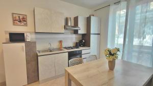 a small kitchen with a table and a refrigerator at Agave in Olmedo +14 photos