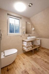 a bathroom with a tub and a sink and a toilet at Apartmány Ella in Hřensko +33 photos