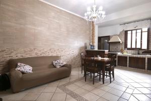 a living room with a couch and a table at Free Parking - Maria House in Torre del Greco
