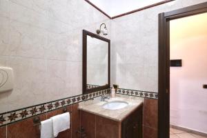 a bathroom with a sink and a mirror at Free Parking - Maria House in Torre del Greco +7 photos