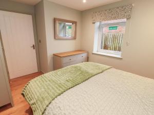 a bedroom with a bed and a window at The Nook in Wigton
