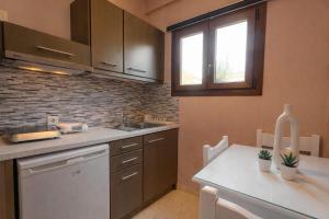 a kitchen with a sink and a counter top at Villa Fotini in Syvota