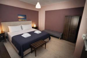 a bedroom with a bed with two towels on it at Villa Fotini in Syvota