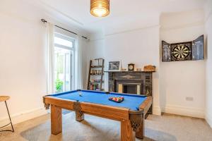 a room with a pool table and a fireplace at 4 Bed in St. Austell oc-t32965 in St Austell