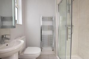 a bathroom with a toilet and a sink and a shower at 4 Bed in St. Austell oc-t32965 in St Austell +15 photos