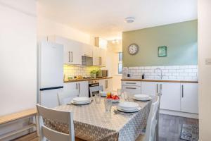 a kitchen and dining room with a table and chairs at 4 Bed in St. Austell oc-t32965 in St Austell