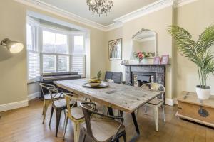 a dining room with a table and chairs and a fireplace at 5 Bed in Llangollen oc-l34205 in Llangollen