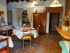 a dining room with a table and chairs in a room at Ai Tigli in Castel dʼArio +21 photos