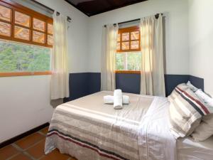 a bedroom with a bed with two towels on it at Casarão in Marechal Floriano