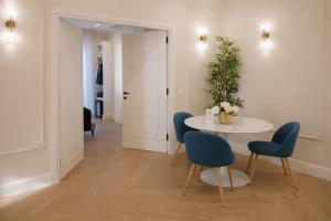a dining room with a table and blue chairs at SOFIA Suites & Rooms in Pompei +28 photos