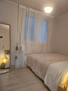 a bedroom with a bed and a large window at STAY Humming in Seoul