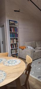 a living room with two tables and a couch at Садиба Пташка in Krivopolʼye