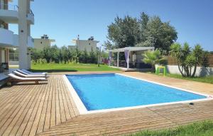 a swimming pool in the backyard of a house at 7 Bedroom Cozy Home In Preveza in Preveza