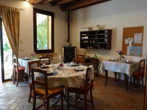 a dining room with tables and chairs and a fireplace at Ai Tigli in Castel dʼArio