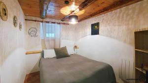 a small bedroom with a bed in a room at La Ferrandaise in Chambon-sur-Lac