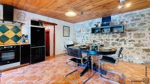 a kitchen with a table in a room at La Ferrandaise in Chambon-sur-Lac +2 photos