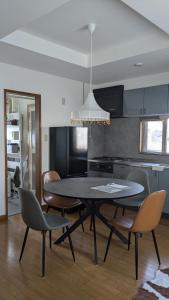 a dining room with a table and chairs in a kitchen at Aioi house in Tsubetsu