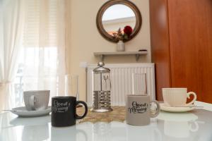 a group of coffee mugs sitting on a table at Stergios_Apartments 05 in Kozani