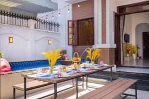 a dining room with a table with food on it at Villa 25 Lạc Long Quân in Vung Tau