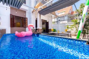 an inflatable pink flamingo in a swimming pool in a house at Villa 25 Lạc Long Quân in Vung Tau