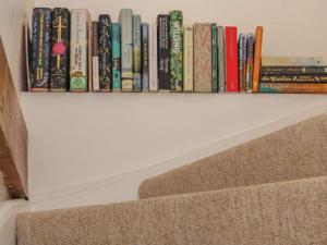 a row of books on a book shelf at The Old Studio in Penzance