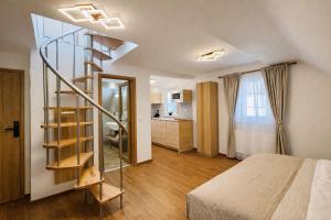 a bedroom with a spiral staircase next to a bed at Apartmány Ella in Hřensko