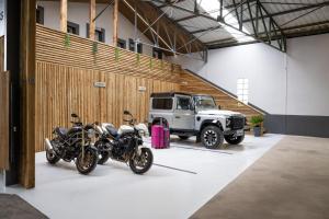 two motorcycles parked in a garage with a truck at Studio Le Rubis tout inclus petitdéjeuner in Éloyes