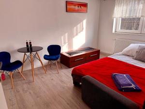 a bedroom with a bed and a table and chairs at Silesia młyn in Katowice +17 photos