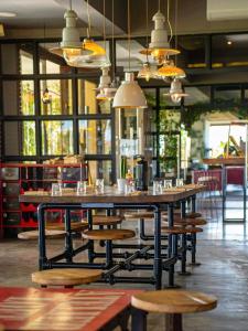 a large table and benches in a restaurant at Cozy Golf Apartment Wifi 4k-TV Netflix in Marrakesh