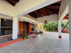 an outside view of a house with a patio at Rego Farms in Mangalore