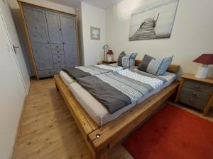 a bedroom with a large bed with a wooden frame at Birkenquartier in Zingst