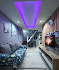 a living room with a couch and a purple ceiling at Kundasang height valley in Ranau