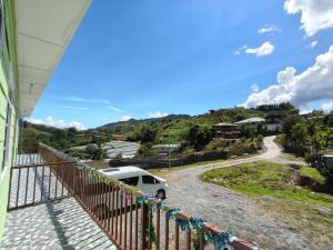 a van parked on the driveway of a house at Kundasang height valley in Ranau +6 photos
