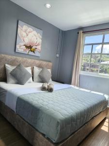 a bedroom with a bed with two teddy bears on it at Kundasang height valley in Ranau